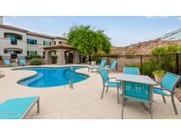 Community pool featuring lounge seating, covered ramada, and desert landscaping at 3236 E Chandler Blvd # 2028, Phoenix, AZ 85048