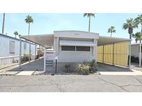 Charming mobile home featuring covered parking and well-maintained landscaping in a vibrant community at 345 S 58Th St # 10, Mesa, AZ 85206