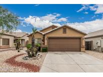 Single-story home with a two-car garage, desert landscaping, and a neutral color scheme at 3703 S 73Rd Dr, Phoenix, AZ 85043