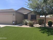 Charming single-story home with a well-maintained desert landscape and artificial grass lawn at 4657 E Del Rio Dr, San Tan Valley, AZ 85140