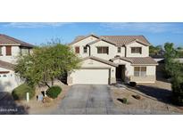 Charming two-story home showcasing a well-manicured yard and welcoming two-car garage at 4804 S 25Th Dr, Phoenix, AZ 85041