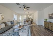 Spacious living room with ceiling fan flows into the dining area and kitchen at 5096 S 245Th Dr, Buckeye, AZ 85326