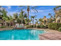 Beautiful community pool with fountains, palm trees, and well maintained landscaping at 5335 E Shea Blvd # 1094, Scottsdale, AZ 85254