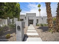 Stunning modern home featuring a desert landscape with cacti, a concrete walkway, and a neutral-toned facade at 6333 N Scottsdale Rd # 5, Scottsdale, AZ 85250