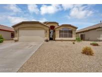 Charming single-story home featuring a well-maintained front yard with desert landscaping and attached two-car garage at 10226 W Country Club Trl, Peoria, AZ 85383