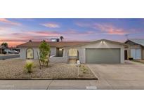 Charming single-story home featuring a well-maintained front yard with desert landscaping and a two-car garage at 10612 N 48Th Ave, Glendale, AZ 85304