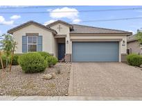 Charming single-story home with manicured landscaping and a brick-paved driveway at 12105 W Wier Ave, Avondale, AZ 85323