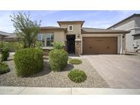 Charming single-story home featuring a well-manicured front yard and attached two-car garage at 23018 E Mewes Rd, Queen Creek, AZ 85142