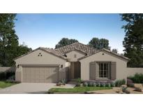Charming single-story home featuring a tile roof, neutral stucco, and a well-manicured front yard with desert landscaping at 23189 W Winslow Ave, Buckeye, AZ 85326