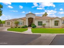 Stunning single-story home featuring a well-manicured lawn, mature landscaping, and a charming walkway leading to the front door at 2625 N 24Th St # 22, Mesa, AZ 85213