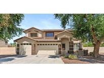 Charming two-story home featuring a three car garage, neutral paint scheme, and a well-maintained landscape at 2648 E Teakwood Pl, Chandler, AZ 85249