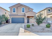 Charming two-story home featuring a neutral color scheme, arched windows and a two car garage at 36085 W Prado St, Maricopa, AZ 85138