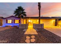 Charming home featuring desert landscaping, two palm trees, and a covered garage at 3643 E Friess Dr, Phoenix, AZ 85032