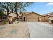 Charming single-Gathering home featuring a well-maintained yard, a desert landscape, and a two-car garage at 4587 E Silverbell Rd, San Tan Valley, AZ 85143