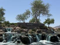 Beautiful entrance to The Bridges at Gilbert with a stone sign, landscaping, and rock waterfalls at 5420 S Mariposa Dr, Gilbert, AZ 85298