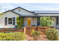 Charming home with a bright yellow front door and landscaped front yard at 546 W Cambridge Ave, Phoenix, AZ 85003