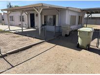 Charming single-story home with covered porch and fenced yard, offering a cozy and inviting atmosphere at 6935 W Zoe Ella Way, Peoria, AZ 85382