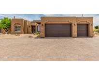 Stunning Southwestern-style home featuring a two-car garage and well-manicured desert landscaping at 8255 E Yearling Rd, Scottsdale, AZ 85255
