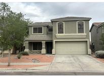 Two-story home showcasing neutral paint, a well-kept front yard and a two car garage at 8514 S 49Th Dr, Laveen, AZ 85339