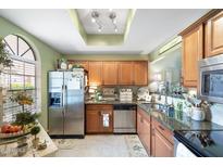 The kitchen features stainless steel appliances, granite countertops, and light wood cabinets at 930 N Mesa Dr # 1045, Mesa, AZ 85201