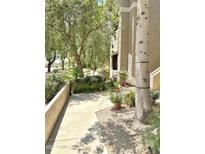 Lush landscaping frames the walkway to this condo, enhancing its curb appeal at 9600 N 96Th St # 267, Scottsdale, AZ 85259