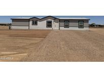 Charming single-story home with a well-maintained front yard, featuring modern siding and a welcoming entrance at 10150 E Shallow Canyon Rd, San Tan Valley, AZ 85143