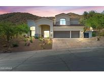 Stunning two-story home with a three-car garage and desert landscaping at 11446 E Sweetwater Ave, Scottsdale, AZ 85259