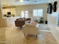 Inviting living room featuring stylish furnishings and neutral decor with lots of natural light from the windows at 13540 N 87Th Dr, Peoria, AZ 85381