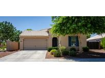 Charming single-story home featuring a well-manicured lawn and attached two-car garage at 18575 W Vogel Ave, Goodyear, AZ 85338