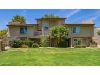 Inviting condo with green lawn, mature trees, and a private balcony at 19601 N 7Th N St # 1072, Phoenix, AZ 85024