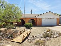 Single-Gathering home showcasing a charming exterior, stucco walls, arched features, desert landscaping, and a two-car garage at 2027 N 81St St, Scottsdale, AZ 85257