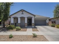Charming single-story home featuring a neutral color palette and well-manicured landscaping at 22463 E Desert Spoon Dr, Queen Creek, AZ 85142