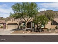 Charming single-story home featuring desert landscaping, a two-car garage, and a tile roof at 26409 N 49Th Ln, Phoenix, AZ 85083
