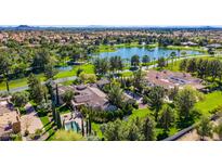 Stunning aerial view of an estate home with pool, lush landscaping, and lake views at 29 E Oakwood Hills Dr, Chandler, AZ 85248