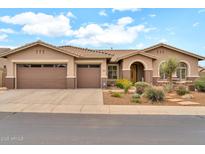 Inviting single-story home with a three-car garage and a well-maintained desert-style front yard at 2959 W Eastman Dr, Anthem, AZ 85086