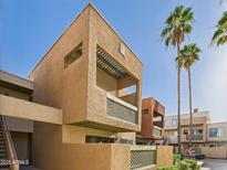 Modern condo exterior featuring a private balcony with palm trees and a blue sky backdrop at 3500 N Hayden Rd # 206, Scottsdale, AZ 85251