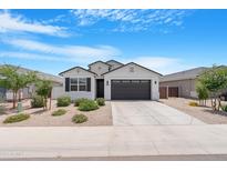 Beautiful single-story home with desert landscaping, a two-car garage, and a neutral color scheme at 35585 W San Alvarez Ave, Maricopa, AZ 85138