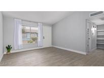 Spacious living room with tile flooring, bright natural light, and neutral paint at 3646 N 67Th Ave # 64, Phoenix, AZ 85033