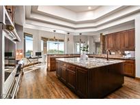 Stunning kitchen with granite counters, wood floors, and stainless steel appliances at 40858 N 109Th Pl, Scottsdale, AZ 85262