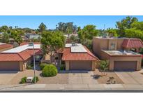 Charming home featuring a red tile roof, desert landscaping, and a two-car garage in a desirable neighborhood at 4346 E Bannock St, Phoenix, AZ 85044