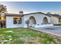 Charming home featuring an arched entryway, a modern design, and a well-maintained lawn at 5222 N 41St Ave, Phoenix, AZ 85019