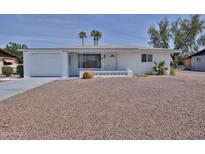 Charming single-story white home with a well-manicured yard and desert landscaping at 5510 E Dallas St, Mesa, AZ 85205