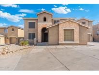 Two-story home featuring stone accents, archway entrance, desert landscaping, and a spacious concrete driveway at 6202 W Maya Dr, Phoenix, AZ 85083