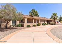Inviting single story home featuring a well-manicured front yard, mature trees and a circular driveway at 6316 W Corrine Dr, Glendale, AZ 85304