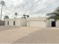 Contemporary white home with a two-car garage, desert landscaping, and a private courtyard at 6529 E Eugie Ter, Scottsdale, AZ 85254