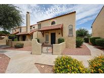 Attractive condo with red tile roof, stucco walls, gated courtyard, and lush plants at 6533 N 7Th Ave # 18, Phoenix, AZ 85013