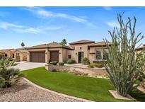 Charming home featuring beautiful landscaping, a well-maintained lawn, and a three-car garage at 654 E County Down Dr, Chandler, AZ 85249