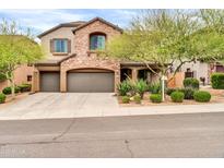 Charming two-story home with a three car garage, stone accents and low-maintenance landscaping at 9034 W Eagle Talon Dr, Peoria, AZ 85383