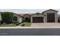 Charming single-story home with a stone facade, well-manicured lawn, and a three-car garage at 9187 W Parkside Ln, Peoria, AZ 85383