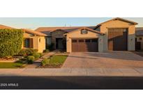 Charming single-Gathering home featuring a brick driveway, three-car garage, and well-maintained landscaping at 9187 W Parkside Ln, Peoria, AZ 85383